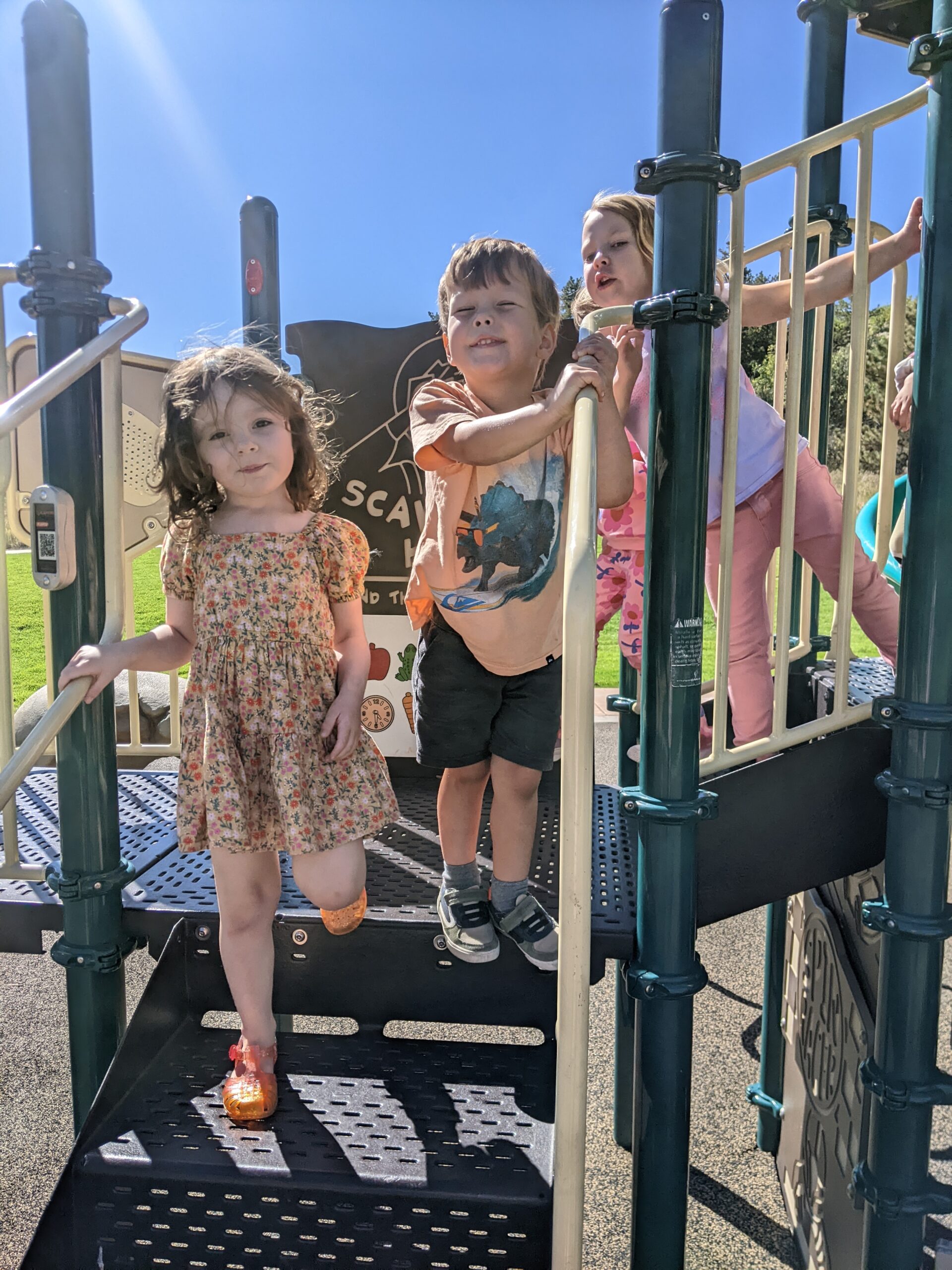 preschool students playing on playground equipment